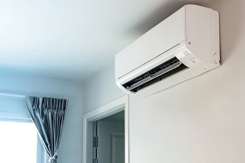 Hot and Cold Spots? Get Even Heating and Cooling in Your Albany Home. Cool air conditioner swing system on wall in room.